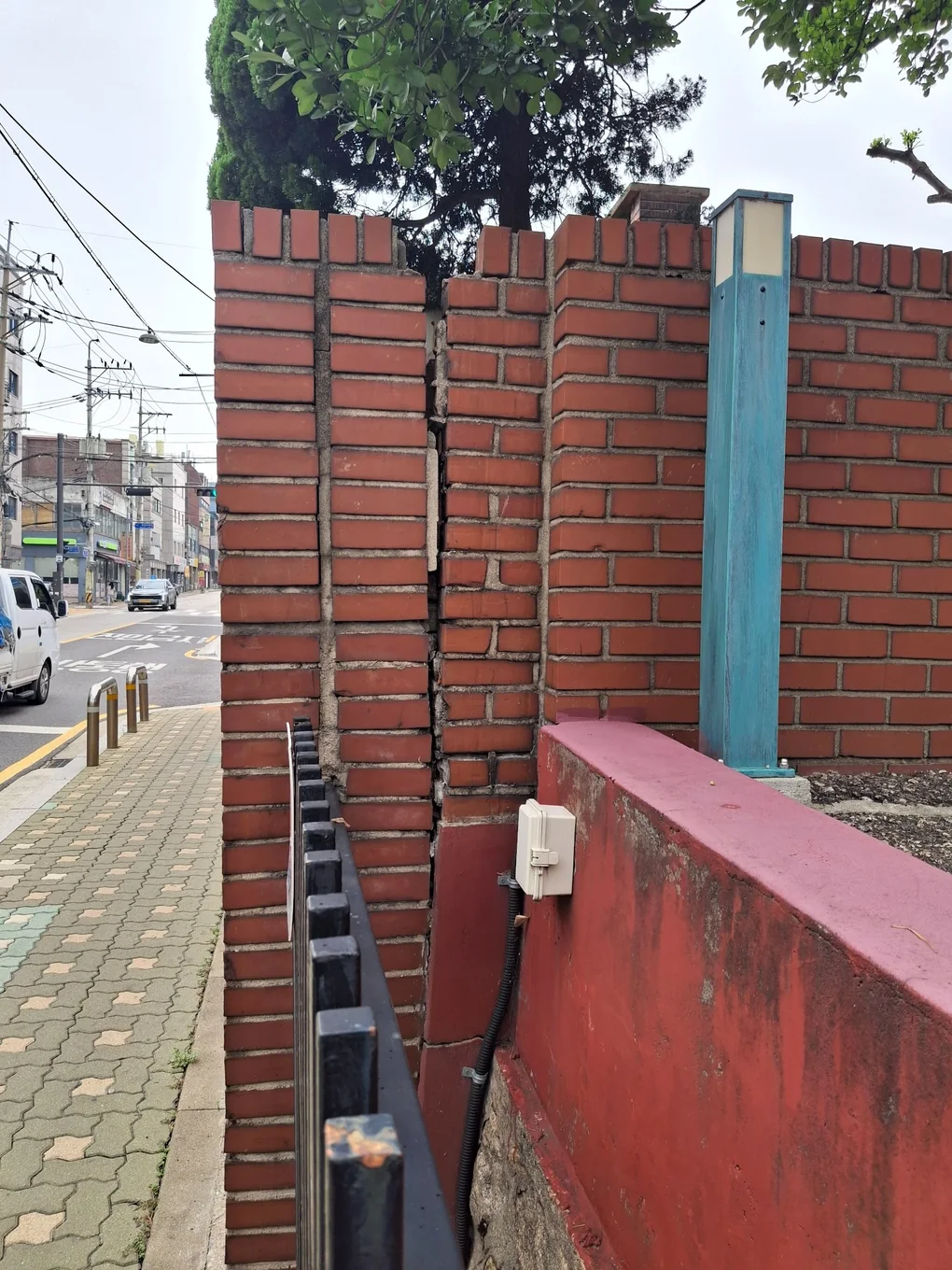 적벽돌 담장 연결부가 상단부터 하부까지 길게 벌어진 작업 전 상태