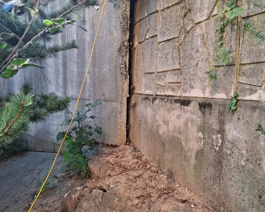 옹벽 경계가 벌어져 뒤쪽 토사가 보이는 상태